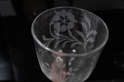Lot 148 - Two Georgian wine glasses, c.1740, the ogee bowls engraved with flowers, with plain stems and folded conical feet, 14.5cm and 14.75cm height