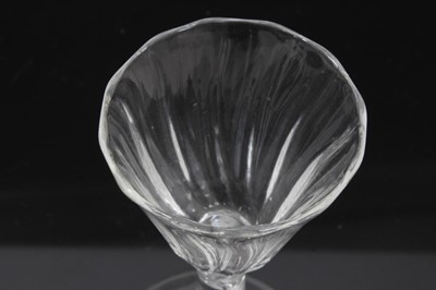 Lot 164 - Georgian air twist wine glass, c.1750, the pointed round funnel bowl with slightly wrythen vertical moulding, the stem with single spiral cable over a conical foot, 13.75cm height