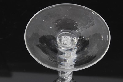 Lot 164 - Georgian air twist wine glass, c.1750, the pointed round funnel bowl with slightly wrythen vertical moulding, the stem with single spiral cable over a conical foot, 13.75cm height