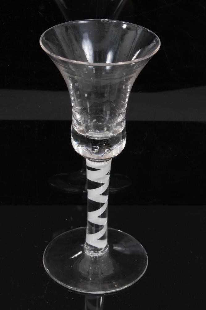 Lot 153 - 18th century continental opaque twist wine glass, the bell bowl over a stem consisting of a heavy spiral band, above a conical foot