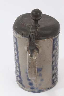 Lot 173 - An 18th Century Westerwald stoneware tankard, with hinged pewter cover