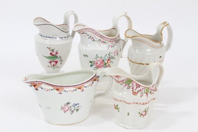 Lot 107 - A rare Keeling and Co Low Bucket Shaped cream jug, circa 1795, pattern number 292, and four helmet shaped cream jugs, circa 1795