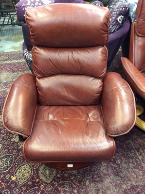 Lot 1035 - Contemporary brownish red leather revolving reclining armchair