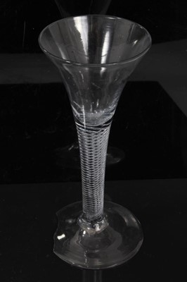 Lot 152 - Three Georgian wine glasses, c.1750, all with drawn trumpet bowls on multi-spiral air twist stems, 16cm to 16.75cm height