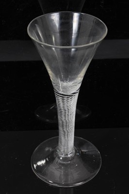 Lot 152 - Three Georgian wine glasses, c.1750, all with drawn trumpet bowls on multi-spiral air twist stems, 16cm to 16.75cm height