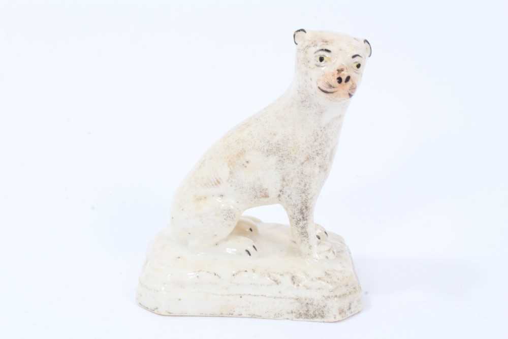Lot 31 - An unusual English porcelain model of a seated lioness, circa 1830-40