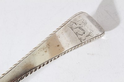 Lot 8 - George III silver old english pattern serving ladle with feather edge, engraved crest and scalloped bowl (London 1769), 6.5oz, 35cm in length