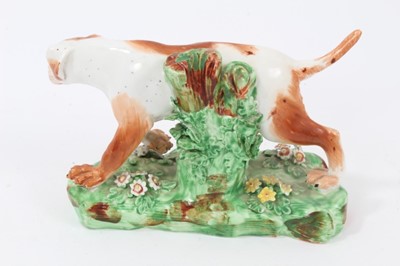 Lot 108 - Late 18th century Derby porcelain model of a Pointer, shown mid-stride on a grassy base, 16cm length from head to tail