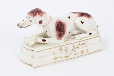 Lot 107 - Staffordshire model of a Pointer, c.1830, shown recumbent, front legs crossed, on a stepped base, enamel painted and gilt-lined, 15cm width