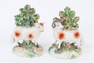 Lot 111 - Pair late 18th century Derby porcelain models of sheep, shown standing on scrollwork bases, with bocage behind them and to the bases, 9.5cm height