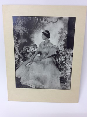 Lot 54 - H.M. Queen Elizabeth , fine 1939 Cecil Beaton black and white portrait photograph - The Queen wearing a beautiful sequinned ball gown and jewels with a painted classical garden scene backdrop, moun...