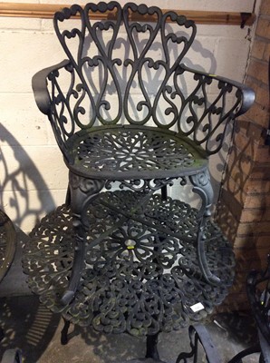 Lot 1043 - Cast iron garden table with four chairs