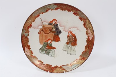 Lot 143 - Japanese Meiji period charger painted with three female figures and a cauldron, together with a further charger and a pair of smaller dishes, the largest measuring 33.5cm diameter