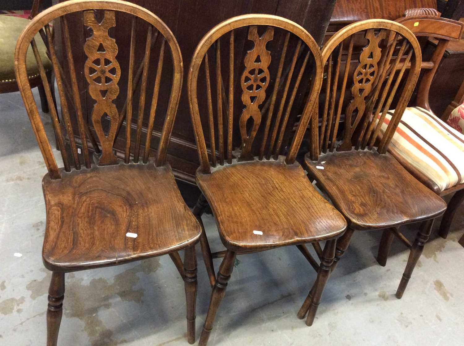 Lot 1020 - Three elm and oak wheel back chairs