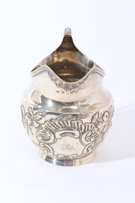 Lot 121 - George III silver milk / cream jug of bellied form with chased floral, foliate and scroll decoration (possibly later added), (London 1804), makers mark rubbed, all at 3.5oz, 10.3cm in height