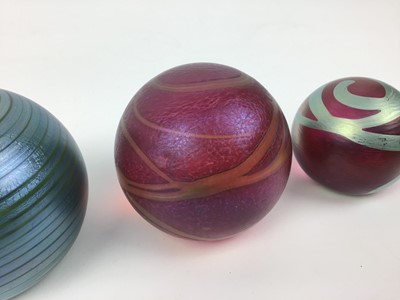 Lot 612 - Three Okra art glass paperweights by Richard Goulding (3)