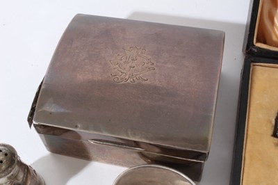 Lot 134 - George V silver cigarette box of rectangular form with domed hinged cover (Birmingham 1924) together with a silver three piece cruet set and a quantity of silver and white metal flatware and napkin...