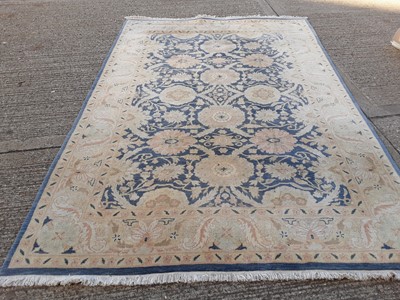 Lot 1066 - Large rug with floral decoration on blue and cream ground, 298cm x 204cm