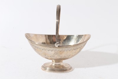 Lot 150 - Gerorge III silver dish of navette form with brite cut engraved decoration, with reeded swing handle, raised on oval pedestal foot with reeded decoration, (London 1790), all at 12oz, 18cm in length