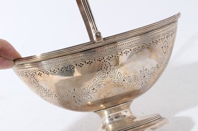Lot 150 - Gerorge III silver dish of navette form with brite cut engraved decoration, with reeded swing handle, raised on oval pedestal foot with reeded decoration, (London 1790), all at 12oz, 18cm in length