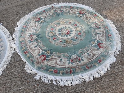 Lot 1070 - Two circular Chinese rugs with floral decoration, 161cm diameter and 128cm diameter