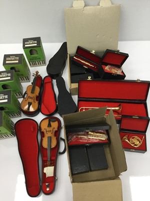 Lot 122 - Collection of novelty miniature instruments, the majority cased, together with models of composers