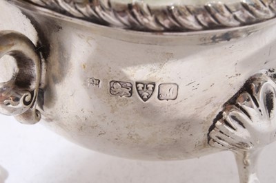 Lot 166 - George V silver sauce boat of conventional form with gadrooned border and scroll handle raised on three paw feet, (Chester 1912), 12.5oz, 22cm in length