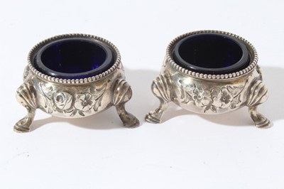 Lot 167 - Pair of Victorian silver salts of cauldron form with embossed decoration, beaded border and blue glass liners, raised on three pad feet, (London 1866) together with a Victorian silver mounted glass...