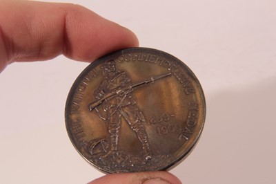 Lot 384 - G.B. - Silver Medallion, South African War, National Commemorative 1900 Obv. soldier his head bandaged, stands on rugged ground cocking rifle etc. Rev: Union Flag and Palm Branch etc. (diameter 45m...