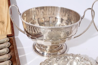 Lot 181 - George V silver bowl with faceted decoration and twin side handles, with presentation inscription, raised on circular foot, (Sheffield 1931), maker Mappin and Webb, together with a quantity of Geor...