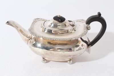 Lot 182 - Edwardian silver teapot of cauldron form with gadrooned and shell border, domed hinged cover with ebony finial and ebony loop handle, (Birmingham 1903), all at approximately 16oz, 26.5cm in length