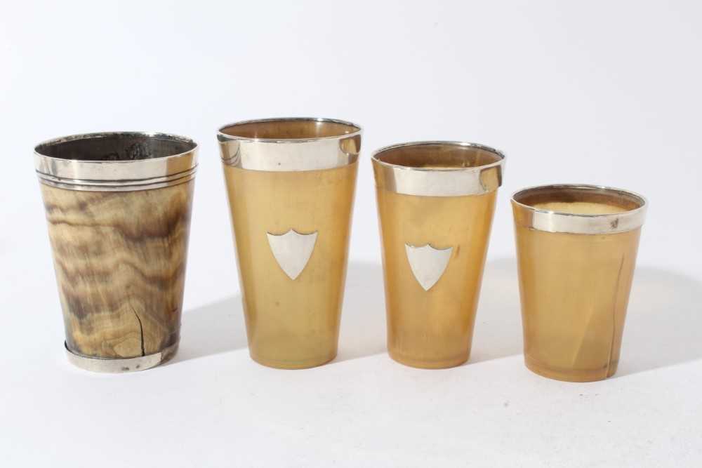 Lot 186 - Group of four Victorian horn beakers of tapered cylindrical form with silver mounts (various dates and makers), the largest 12.8cm in height