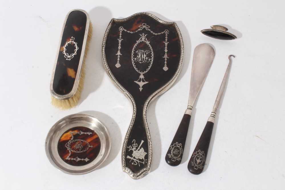 Lot 188 - Edwardian silver and tortoiseshell hand mirror with Adam style decoration (London 1909) together with four other silver and tortoiseshell items (various dates and makers) (4)