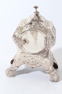 Lot 191 - Edwardian Art Nouveau silver mantel clock in a decorative case with embossed floral and foliate decoration, hinged rear door, raised on four legs, (London 1907), maker William Comyns, 16.5cm in ove...