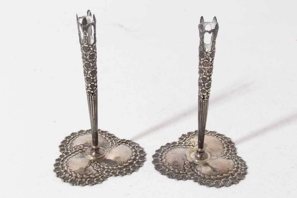 Lot 192 - Pair of early 20th century American silver bud vase holders, pierced tapered stems with floral decoration, on decorative bases, stamped Tiffany & Co, Sterling, all at 2oz