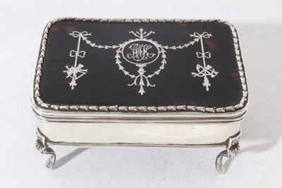Lot 193 - Edwardian silver jewellery / trinket box of rectangular form, with hinged lid set with tortoiseshell and inlaid with Adam style decoration in silver, velvet lined interior, raised on four cabriole...