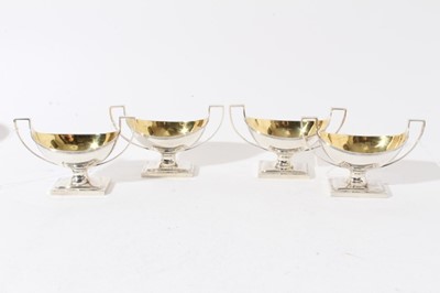 Lot 197 - Set of four George III silver salts of navette form with reeded decoration, gilded interiors and twin angular handles, raised on rectangular pedestal feet, (London 1796) maker Robert Hennell & Davi...