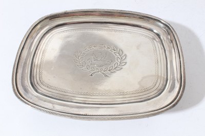 Lot 202 - George III silver teapot stand of oval form with brite cut engraved decoration and central armorial, raised on four feet, (London 1807), all at approximately 5oz, 14.8cm in length