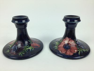 Lot 72 - Pair of Moorcroft pottery candlesticks decorated in the Anemone pattern, impressed marks and original paper labels to both bases - Potters To The Late Queen Mary, 11cm high