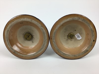 Lot 74 - Pair of Doulton Lambeth candlesticks, impressed marks to base, 20.5cm high