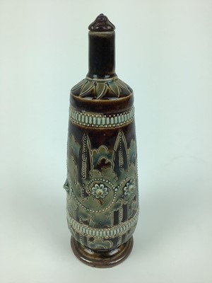 Lot 76 - Unusual Doulton Lambeth bottle and stopper with applied floral and beaded decoration, possibly George Tinworth, impressed marks to base, 21cm high