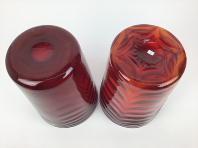 Lot 578 - Two large Whitefriars Ruby red waved ribbed vases, 29cm high
