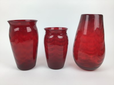 Lot 88 - Three large Whitefriars Ruby red wave ribbed vases, 31cm, 27.5cm and 23.5cm