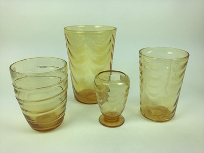Lot 90 - Three Whitefriars Amber wave ribbed vases, 25cm, 19.5cm and 14.5cm plus a ribbon trailed vase, 18cm high (4)