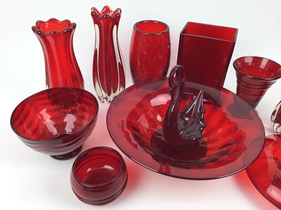 Lot 92 - Twelve pieces of Whitefriars Ruby red glass including large bowl, 31cm diameter,  controlled bubble vase, 20.5cm high, wave bowl, 17cm diameter and ribbon trailed vase, 14cm high