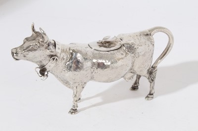 Lot 242 - Late 19th white metal cow creamer, naturalistically modelled, the horned cow with open mouth, textured detail to body, central hinged cover, standing on all fours, with bell around neck (bell detat...