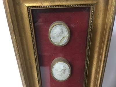 Lot 167 - Group of four 19th century Grand Tour framed plaster cameos, the largest approximately 3.5cm high, with gilt borders, in box frame