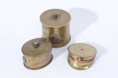 Lot 273 - First World War brass Trench Art pot and cover with Royal Artillery cap badge together with another Trench Art pot and cover and a First World War Trench Art ashtray in the form of an Officers cap...
