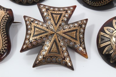 Lot 5 - Group of five 19th century tortoishell piqué work brooches various, with floral decoration to include a Maltese cross brooch, 32-40mm diameter