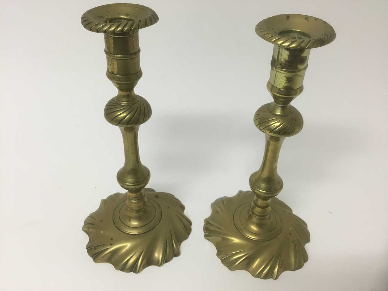 Lot 66 - Pair of George I / II wrythen brass candlesticks